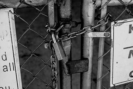 grayscale photography of steel chain with padlocks thumbnail