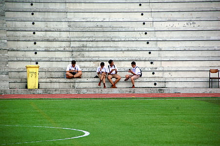 four mens sitting on chair in front of court thumbnail
