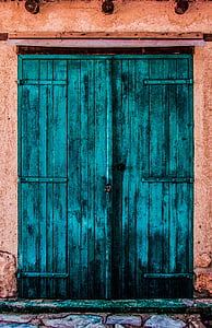 closed teal wooden door thumbnail