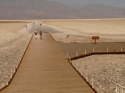 man and woman walking on wooden dock thumbnail