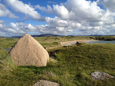 gray rock on grass land during day time thumbnail