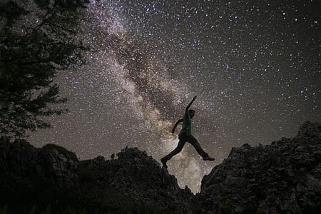 silhouette of man on rocks with galaxy view background on night sky thumbnail
