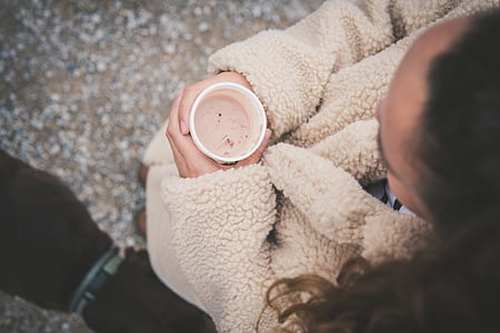 person holding white cup thumbnail