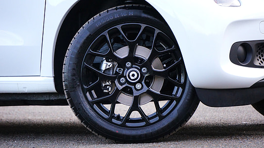 white Smart car with black wheels and tire thumbnail