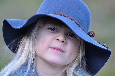 girl wearing blue hat while smiling thumbnail