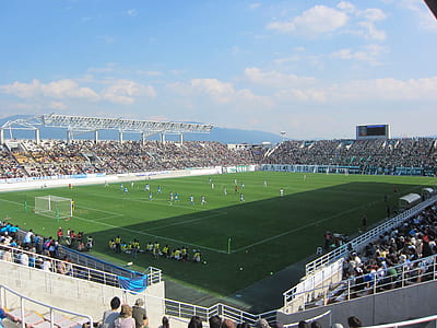 football field during daytime thumbnail