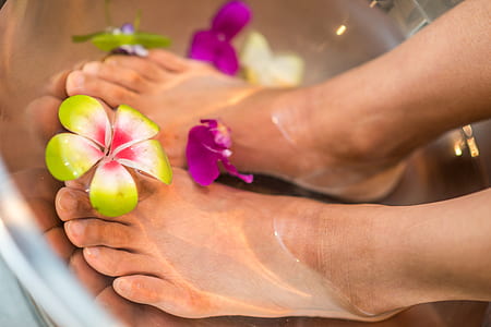 human feet on water with flowers thumbnail