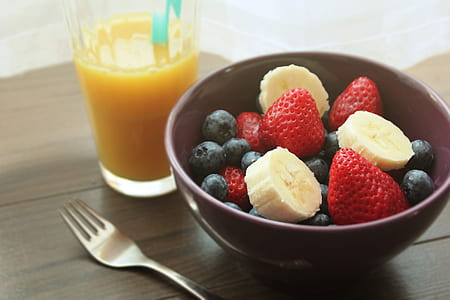 sliced bananas and strawberries on brown bowl thumbnail