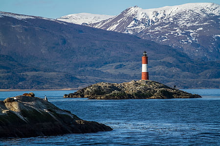 red and white lighthouse on island thumbnail