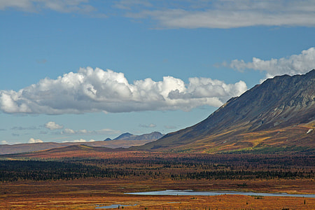 landscape photography of mountain under cloudy sky thumbnail
