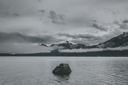 rock monolith surrounded with body of water thumbnail