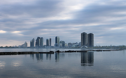 body of water under cloudy sky during daytime thumbnail