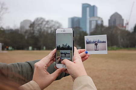 selective focus photography of person taking picture of man in brown coat thumbnail