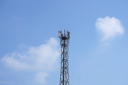 black telecommunication tower under clear blue sky thumbnail