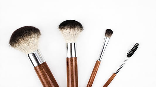 four brown makeup brushes with white background thumbnail