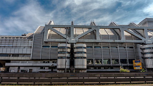 high-rise building under cirrus clouds thumbnail