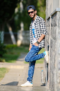man leaning his left foot against the wall thumbnail