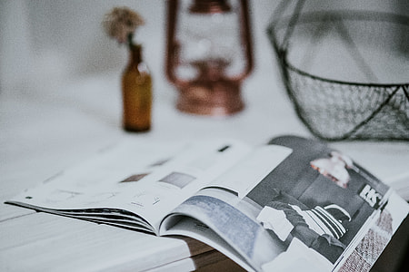 Magazine with a paraffin lamp on a white table thumbnail