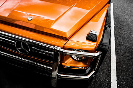 orange Mercedes-Benz G-Class parked on parking space thumbnail