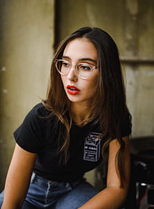 selective focus photography of woman wearing eyeglasses and black polo shirt thumbnail