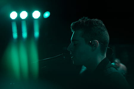 man wearing black shirt singing on stage thumbnail