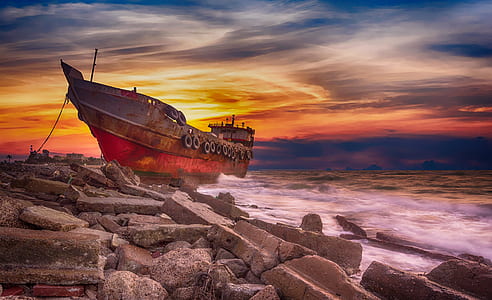 red and gray sail ship on large body of water thumbnail
