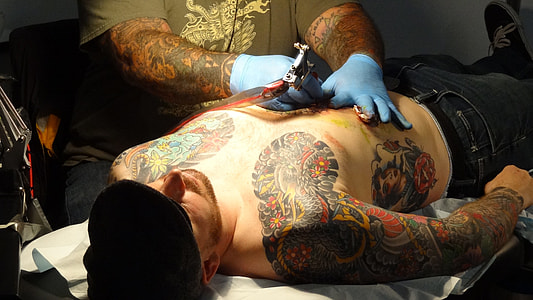 man tattooing thumbnail