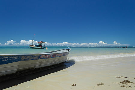 photo of white boat on seashore thumbnail
