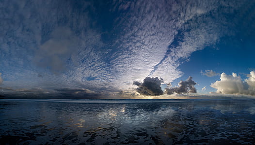 sea under white clouds during daytime thumbnail