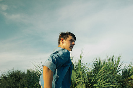 man beside green leafed plant during daytime thumbnail