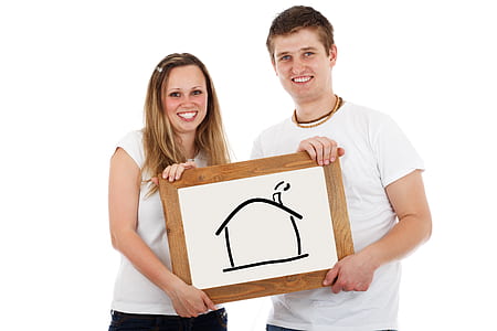 man and woman holding board with house sketch thumbnail