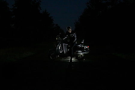 man in motorcycle low light photography thumbnail