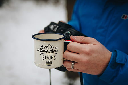 person holding white metal cup thumbnail