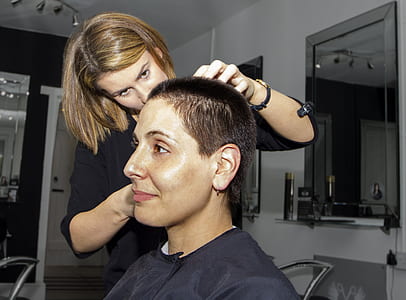 woman having a short hair cut style by a woman beautician thumbnail