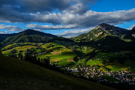 Aerial Photo of Two Mountains Distant from Group of Houses thumbnail