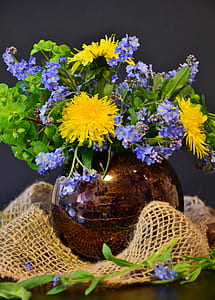 assorted-color petaled flowers inside brown vase thumbnail