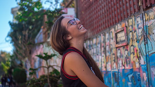 woman smiling in front of graffiti thumbnail