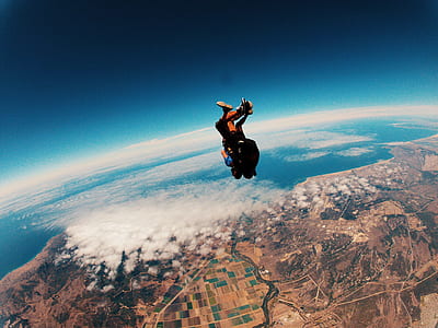 time-lapse photo of two people skydiving during daytime thumbnail