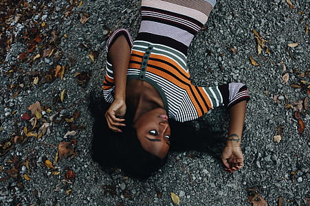 woman laying on ground with dried leaves thumbnail