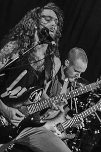 grayscale photography of two guitarists thumbnail