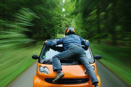 person on orange car thumbnail