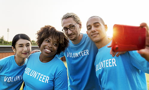 Group of People Wearing Blue Volunteer Shirts thumbnail