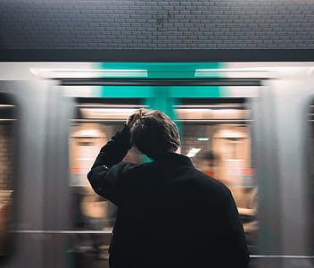man staining beside of gray train thumbnail