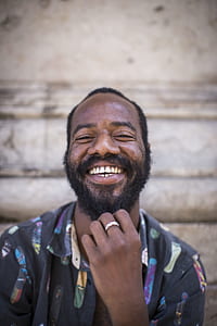 shallow focus photography of a man smiling while taking him a picture thumbnail