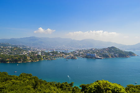 birds eye view of city building beside body of water thumbnail