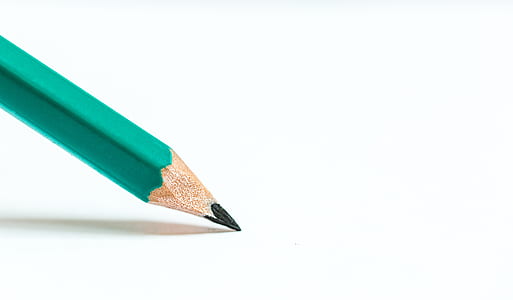 green pencil on top of white paper thumbnail