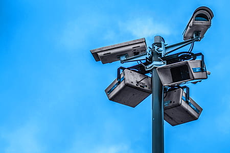 five gray CCTV cameras on gray pole at daytime thumbnail