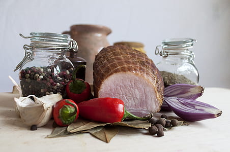 cooked ham beside bell peppers, jars, and red onions thumbnail