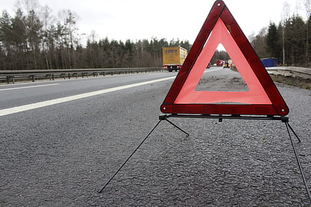 red steel early signage on gray concrete road thumbnail