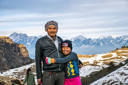 girl hugs man while smiling on mountain thumbnail
